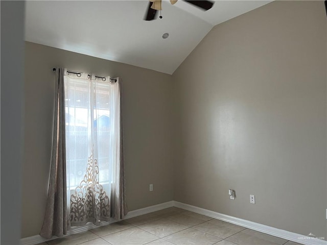 empty room featuring lofted ceiling, ceiling fan, baseboards, and light tile patterned flooring