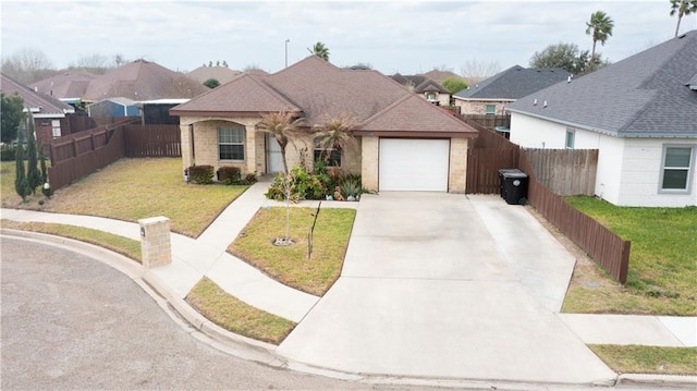 view of front of house featuring a garage, fence, concrete driveway, and a front yard