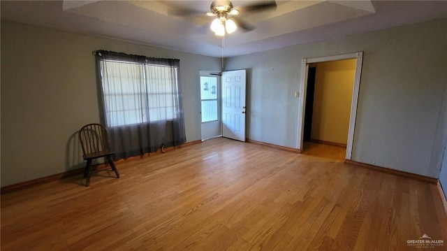 empty room with ceiling fan and light wood-type flooring