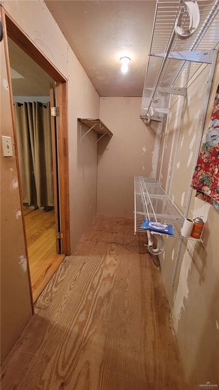 spacious closet with wood-type flooring