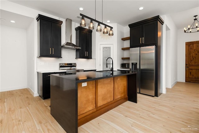 kitchen featuring tasteful backsplash, open shelves, wall chimney exhaust hood, a sink, and appliances with stainless steel finishes