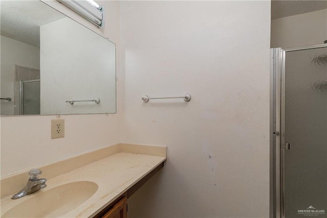 full bathroom featuring a stall shower and vanity