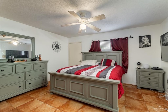 bedroom featuring a ceiling fan and a textured ceiling