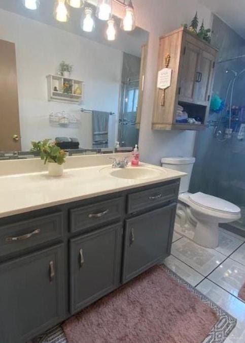 bathroom with vanity, an enclosed shower, and toilet