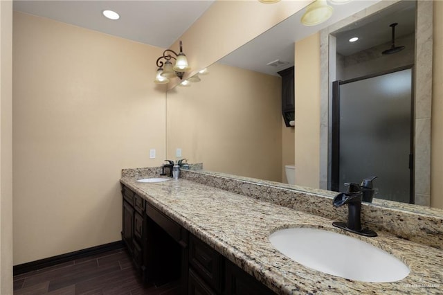 bathroom with toilet, a shower with door, vanity, and hardwood / wood-style flooring