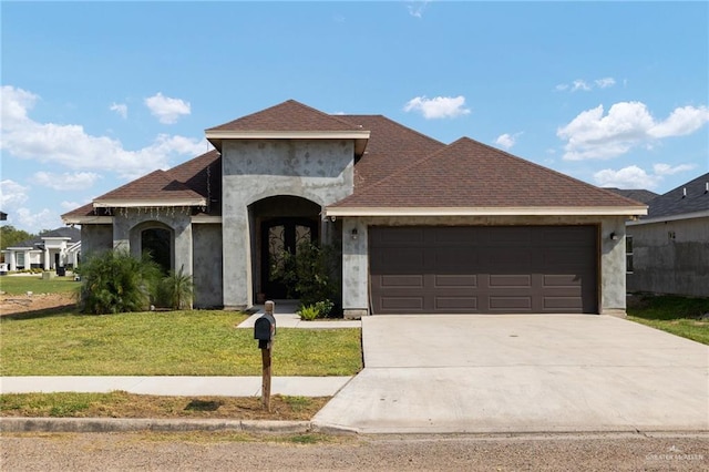 view of front of home with a front lawn and a garage