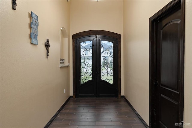 entrance foyer with french doors and dark hardwood / wood-style floors