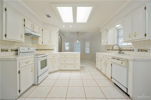 2320 Pelican Ave, Mcallen, TX 78504 - kitchen with white appliances, under cabinet range hood, a sink, tile countertops, and crown molding