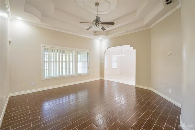 2320 Pelican Ave, Mcallen, TX 78504 - unfurnished room with ceiling fan, a tray ceiling, baseboards, arched walkways, and ornamental molding