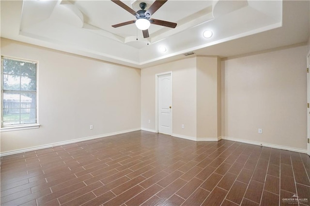 2320 Pelican Ave, Mcallen, TX 78504 - empty room featuring a tray ceiling, a ceiling fan, baseboards, recessed lighting, and dark wood-type flooring