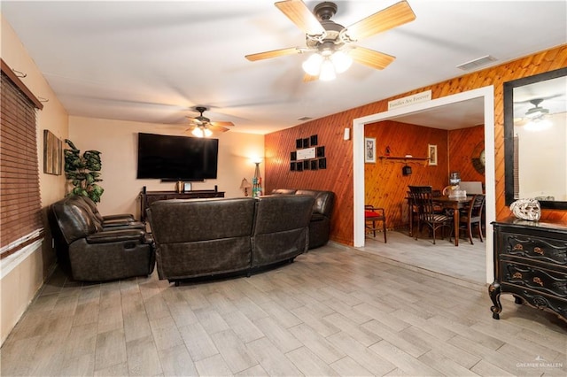 520 W Upas Ave, Mcallen, TX 78501 - living room featuring wooden walls, a ceiling fan, and light wood-type flooring