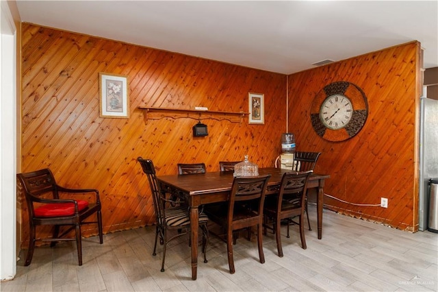 520 W Upas Ave, Mcallen, TX 78501 - dining area featuring light wood-type flooring and wooden walls