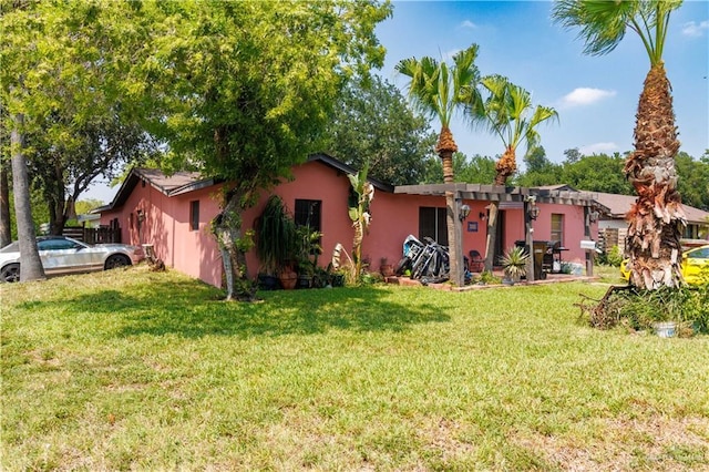 520 W Upas Ave, Mcallen, TX 78501 - rear view of property with a lawn and stucco siding