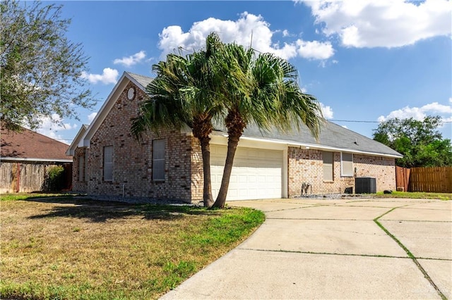 view of side of property featuring a yard and central air condition unit