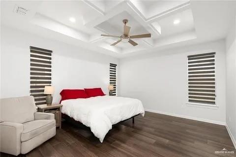 bedroom with recessed lighting, coffered ceiling, wood finished floors, and baseboards