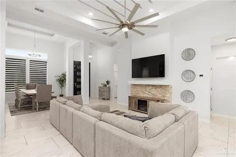 living room with recessed lighting, marble finish floor, visible vents, and a fireplace