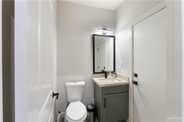 bathroom featuring toilet and vanity