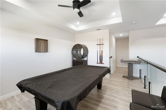 rec room featuring ceiling fan, light hardwood / wood-style flooring, billiards, and a raised ceiling