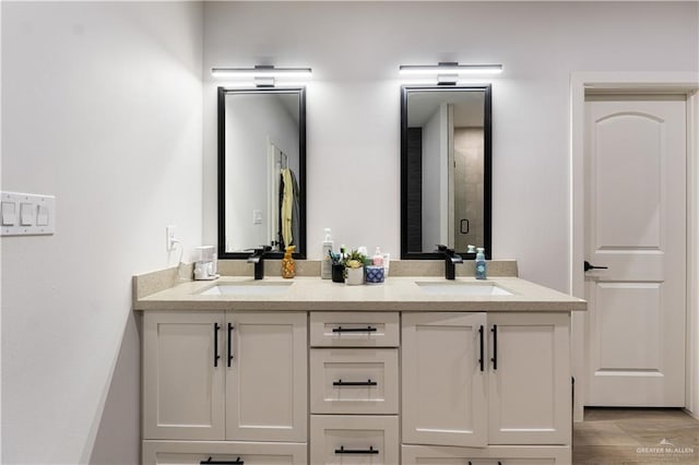 bathroom with walk in shower, hardwood / wood-style floors, and vanity