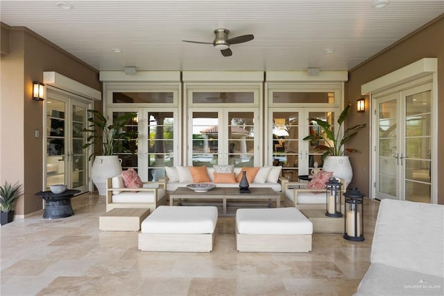 sunroom featuring ceiling fan and french doors