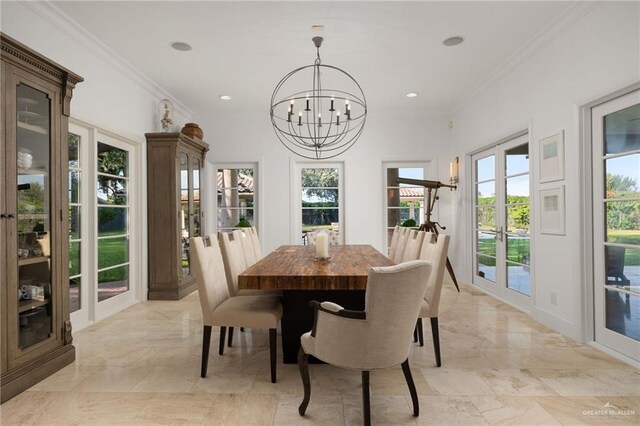 dining area featuring ornamental molding, french doors, and a chandelier