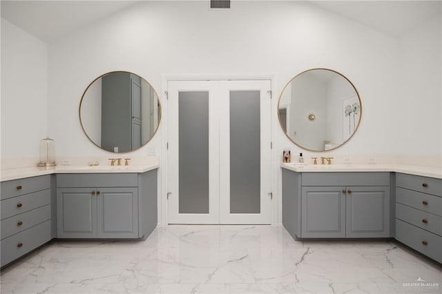 bathroom with vanity and vaulted ceiling