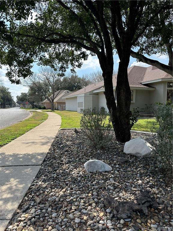 view of side of home with a yard