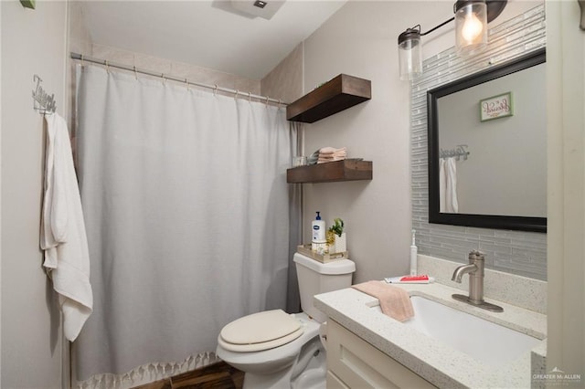 bathroom featuring hardwood / wood-style floors, decorative backsplash, toilet, and vanity