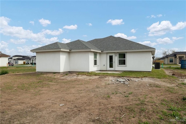 back of property featuring stucco siding and central AC unit