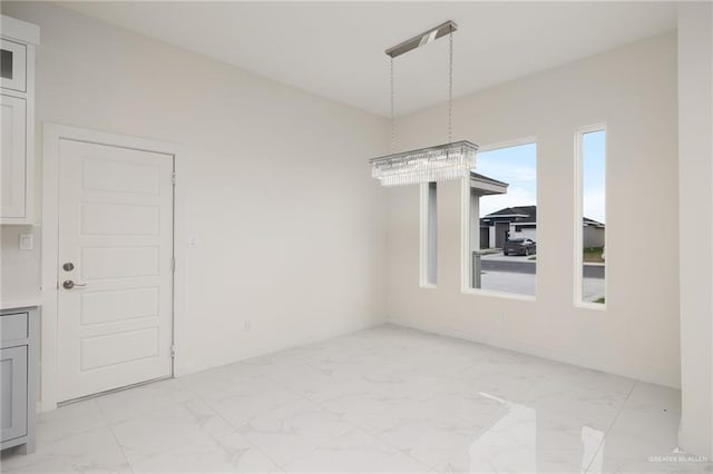 unfurnished dining area with marble finish floor