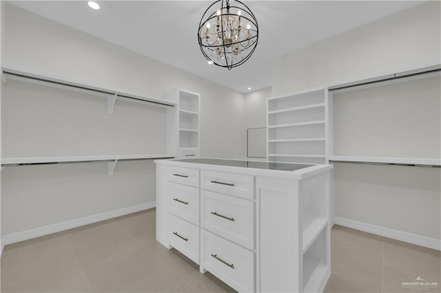 spacious closet with light tile patterned floors and a notable chandelier