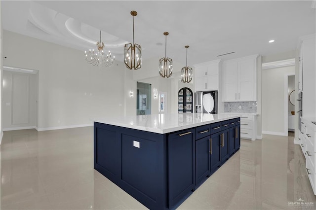 kitchen featuring white cabinetry, decorative light fixtures, a spacious island, and blue cabinets