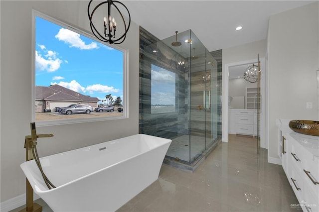 bathroom with shower with separate bathtub, a notable chandelier, and vanity