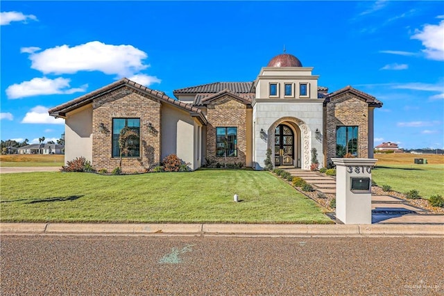 view of front of house featuring a front yard and french doors