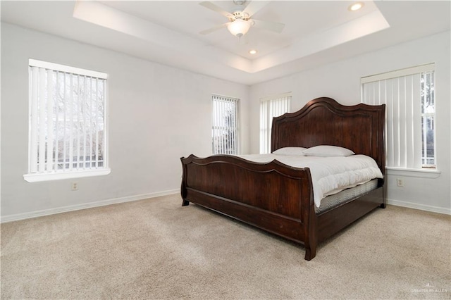 bedroom featuring carpet floors, recessed lighting, a raised ceiling, and baseboards