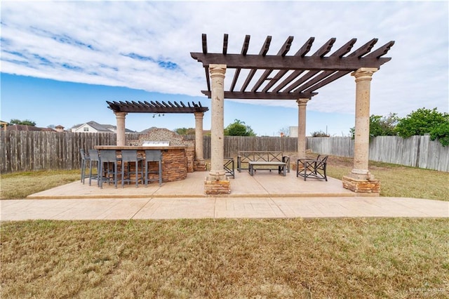 view of patio / terrace with a fenced backyard, outdoor dry bar, and a pergola