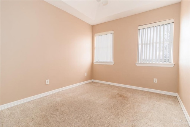 unfurnished room featuring baseboards and carpet flooring