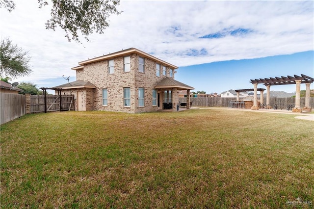 back of house with a fenced backyard, a lawn, and a pergola