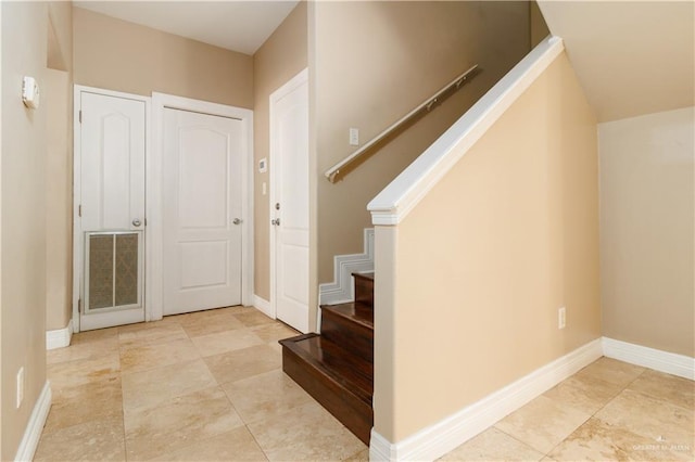 entryway with visible vents, stairway, and baseboards