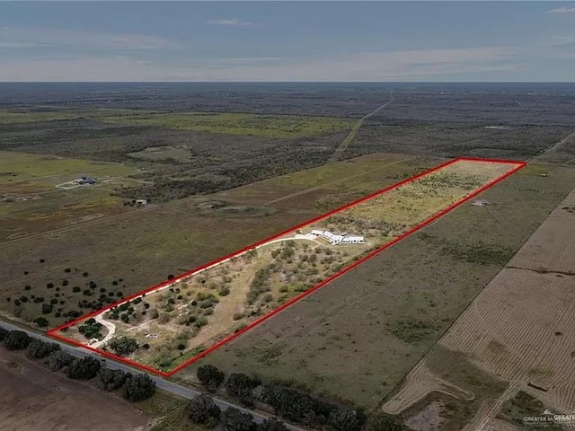 birds eye view of property with a rural view