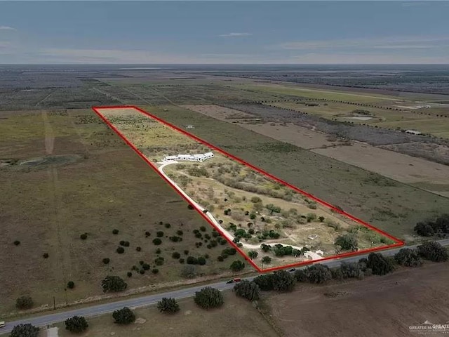 birds eye view of property with a rural view