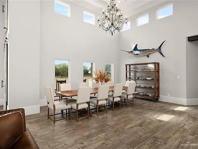 dining area with an inviting chandelier, wood finished floors, and baseboards