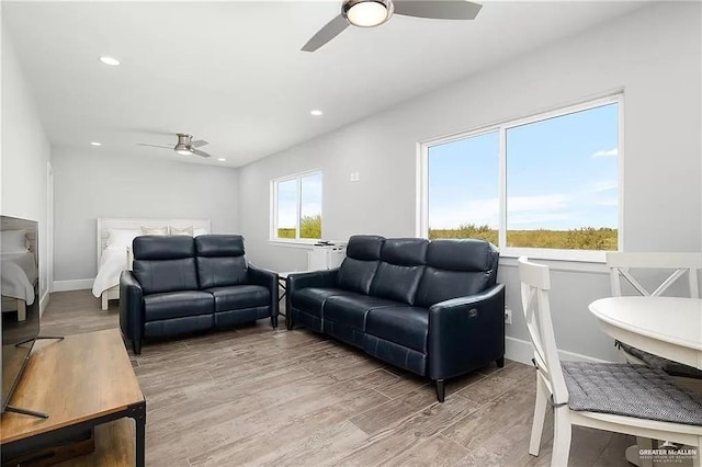 living room featuring ceiling fan, recessed lighting, plenty of natural light, and wood finished floors