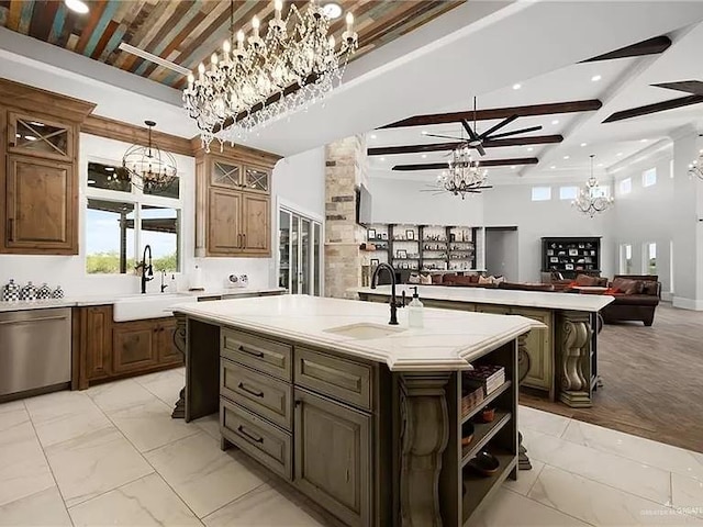 kitchen featuring dishwasher, open floor plan, an inviting chandelier, and an island with sink