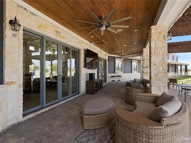 view of patio with outdoor lounge area and a ceiling fan