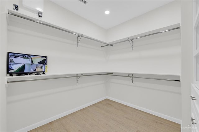 walk in closet featuring light wood-style flooring