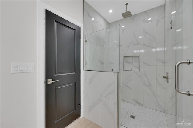 bathroom with recessed lighting and a shower stall