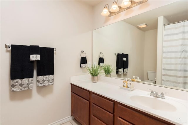 full bathroom featuring vanity and toilet