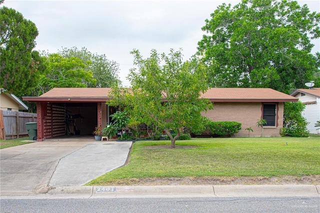 2401 E Austin Ave, Harlingen, TX 78550 - view of front facade featuring brick siding, driveway, and a carport