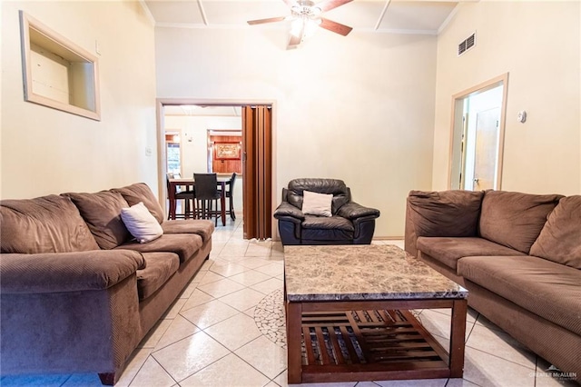 2401 E Austin Ave, Harlingen, TX 78550 - living room with light tile patterned floors, a ceiling fan, ornamental molding, and a high ceiling